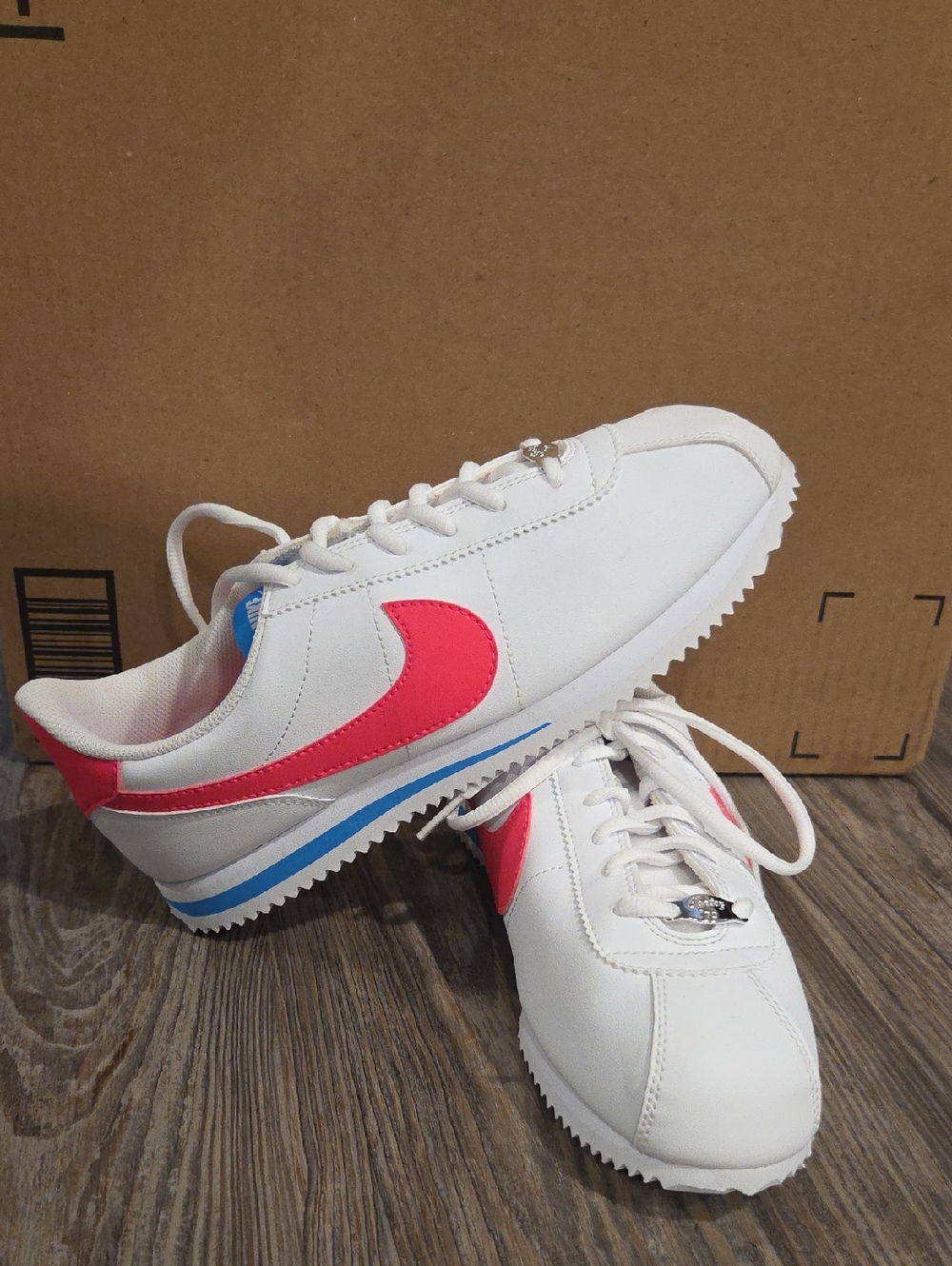 Nike Kids White Sneakers with Pink Swoosh and Blue Accent